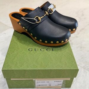 Gucci Black Leather Mules with Gold Detailing